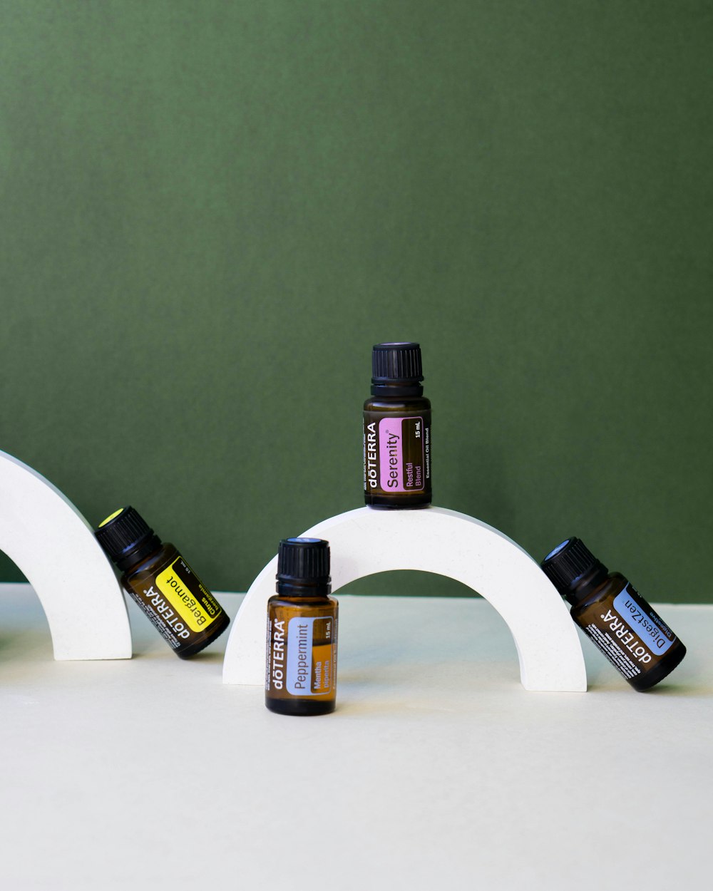 a group of bottles of essential oils sitting on a shelf