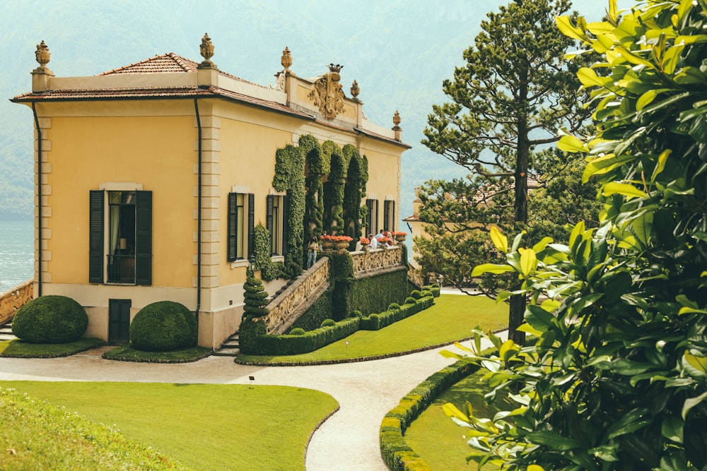 a yellow house with a walkway leading to it