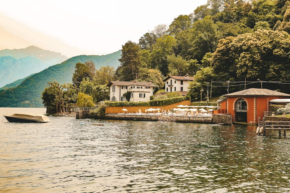 a house on a lake with a boat in the water