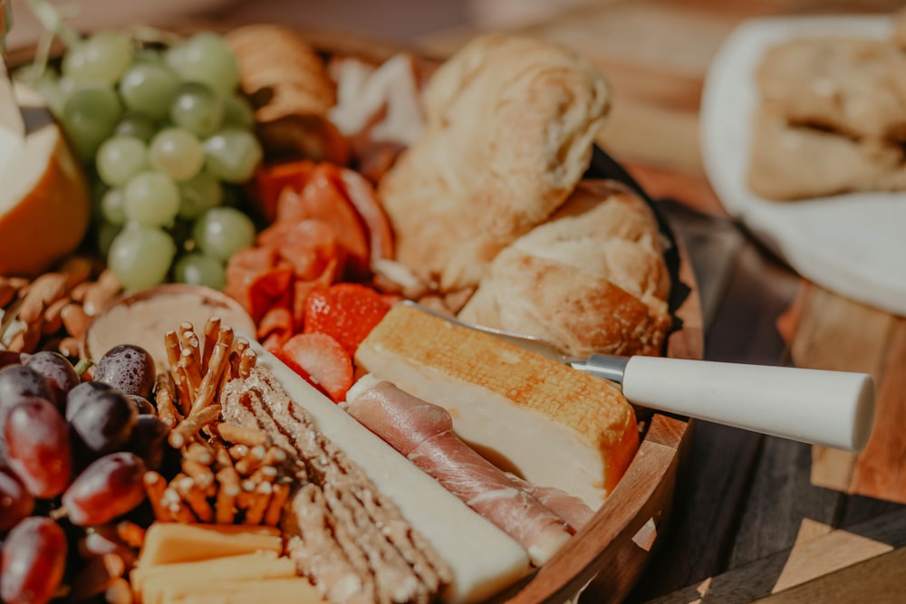 a platter of cheeses, meats, and breads