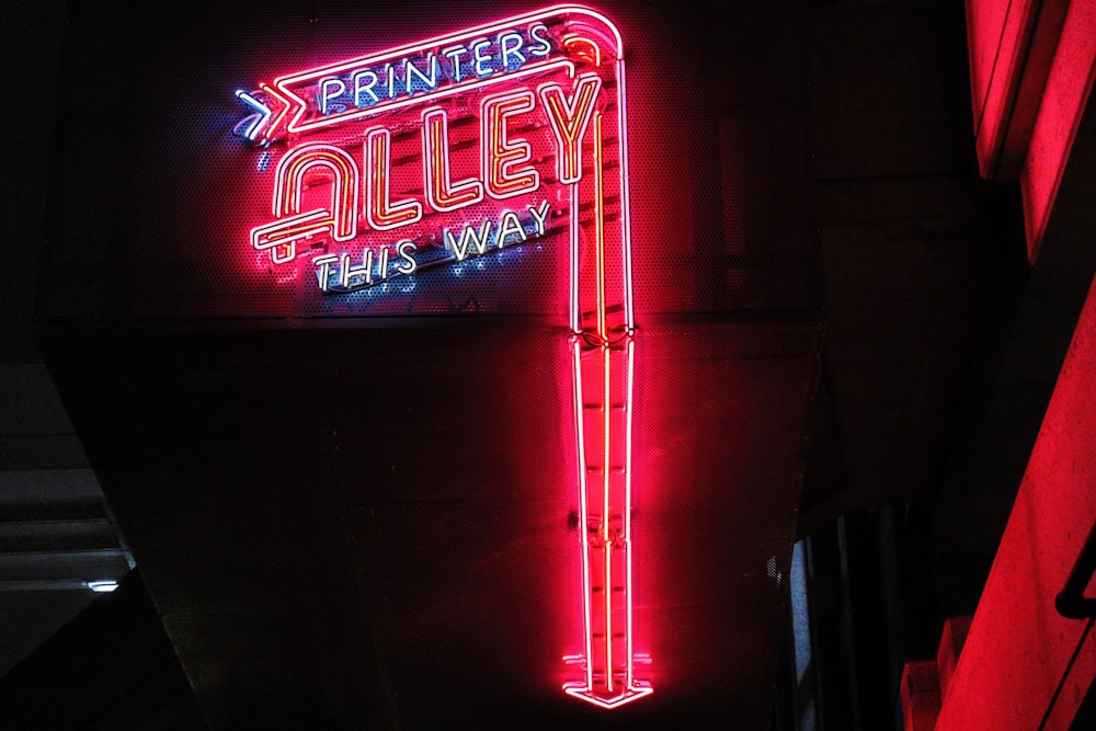 a neon sign that is on the side of a building