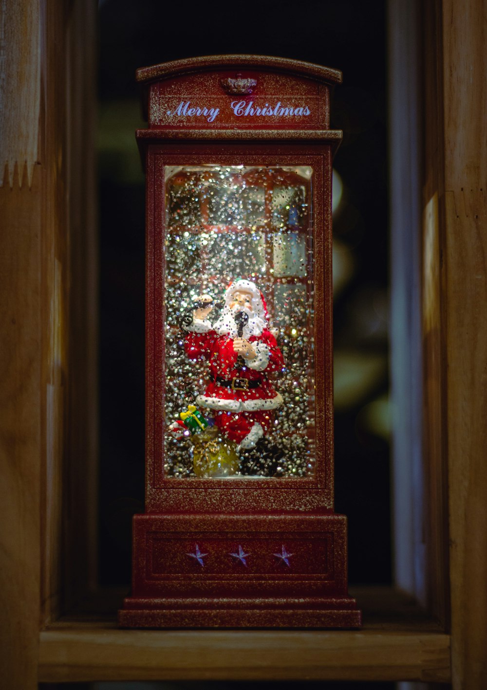 a christmas display in a wooden frame with a santa clause on it
