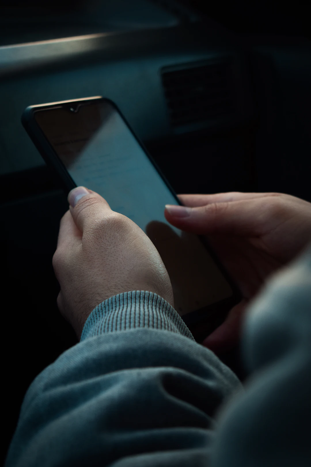 Two hands holding a phone
