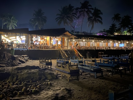 A cozy beachfront dining setup with tropical decor and sunset views.