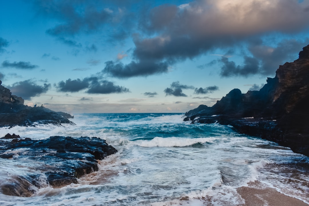 a rocky beach with waves crashing against the rocks,