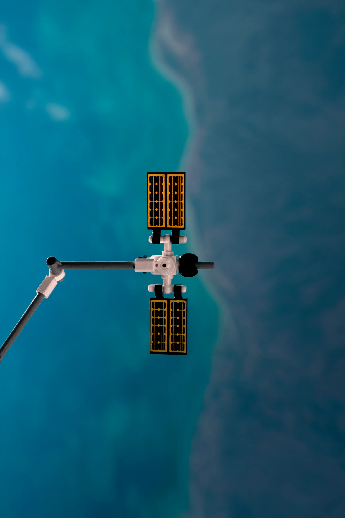 A small satellite with folded solar panels above Earth