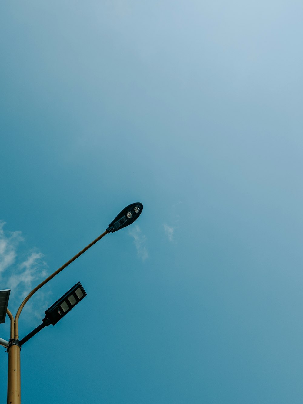 a street light with a blue sky in the background