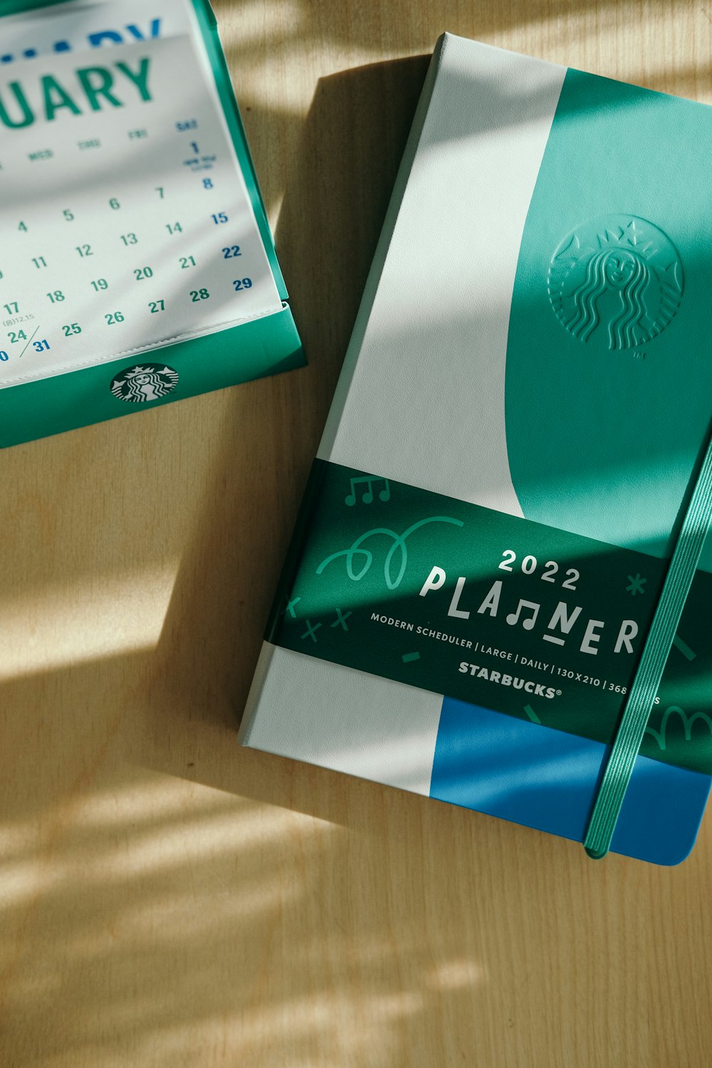 a starbucks planner sitting on top of a wooden table