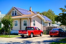 a red pick up truck parked in front of a house