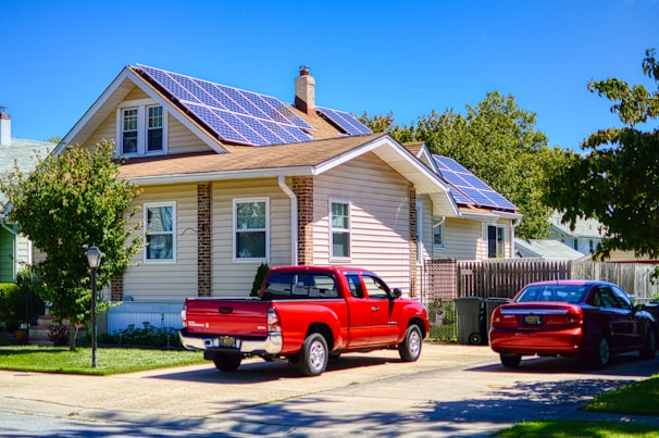 a red pick up truck parked in front of a house