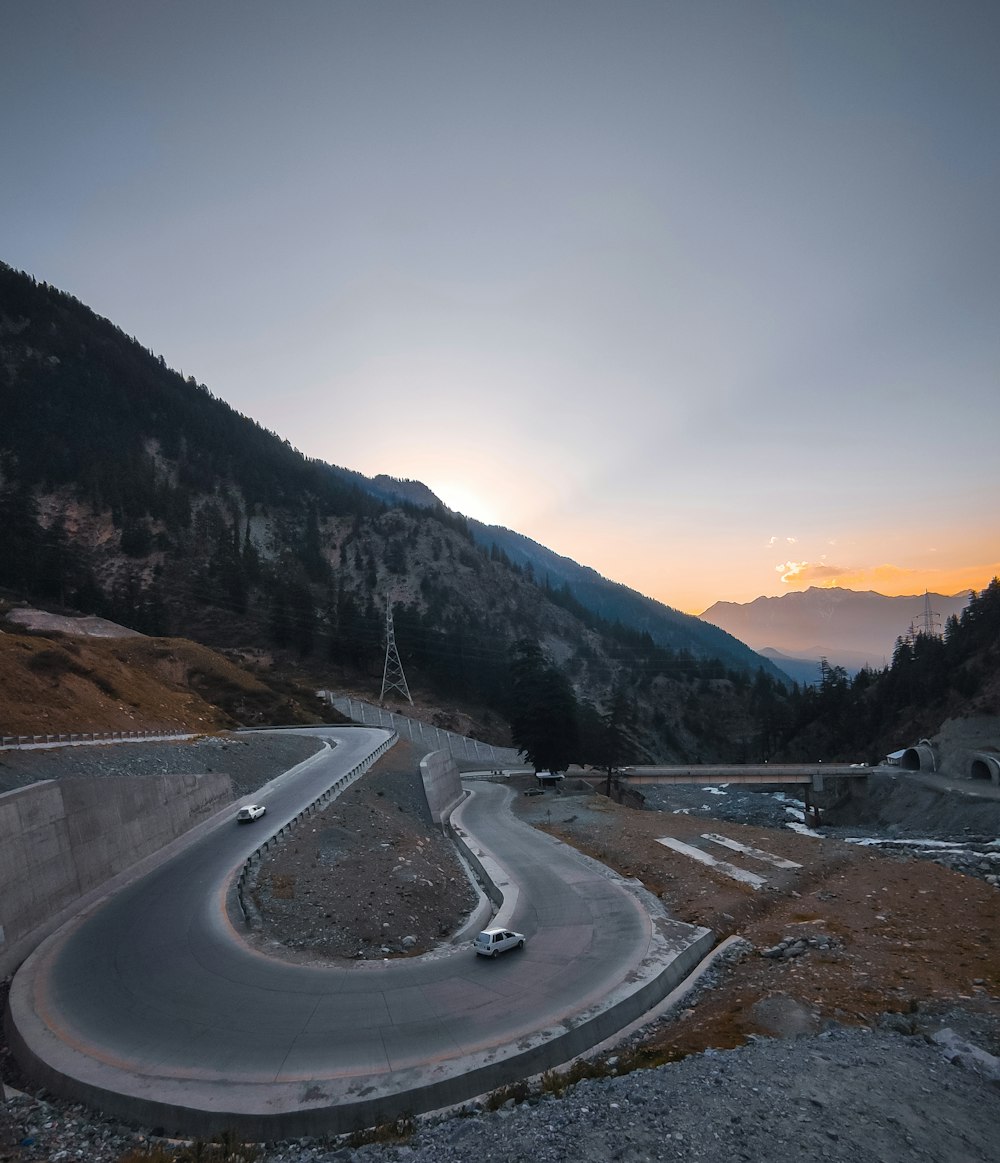 a car driving down a winding road in the mountains