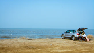 A happy family loading luggage into a spacious rental SUV near the beach.