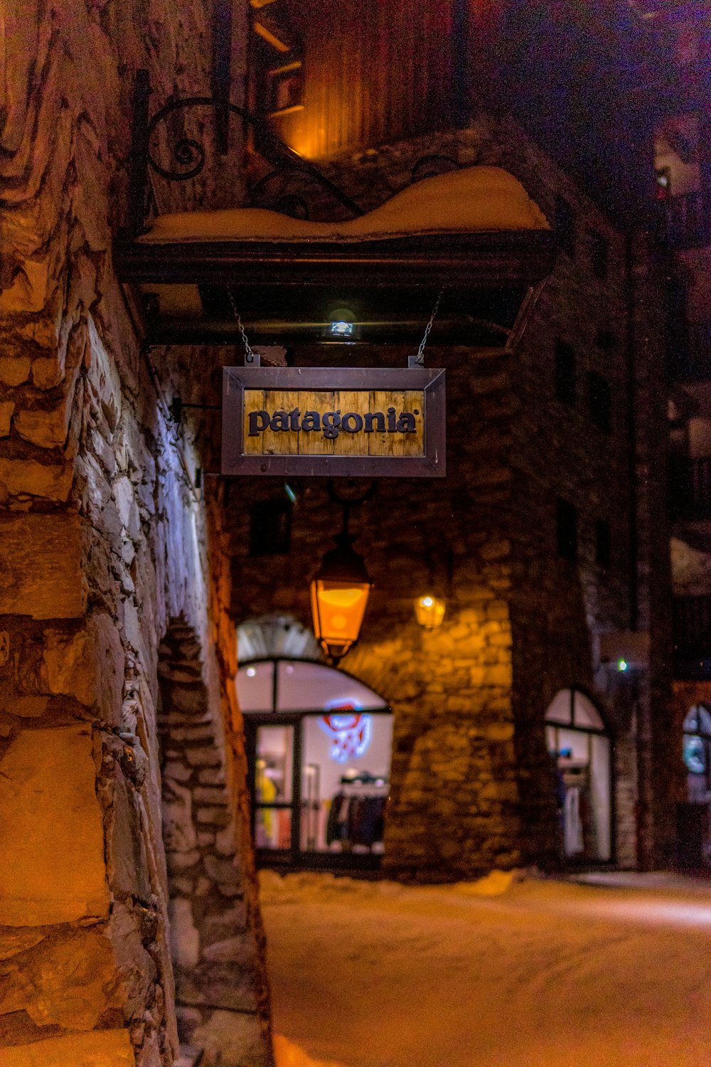 a sign hanging from the side of a stone building