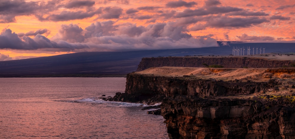 a large body of water sitting under a cloudy sky