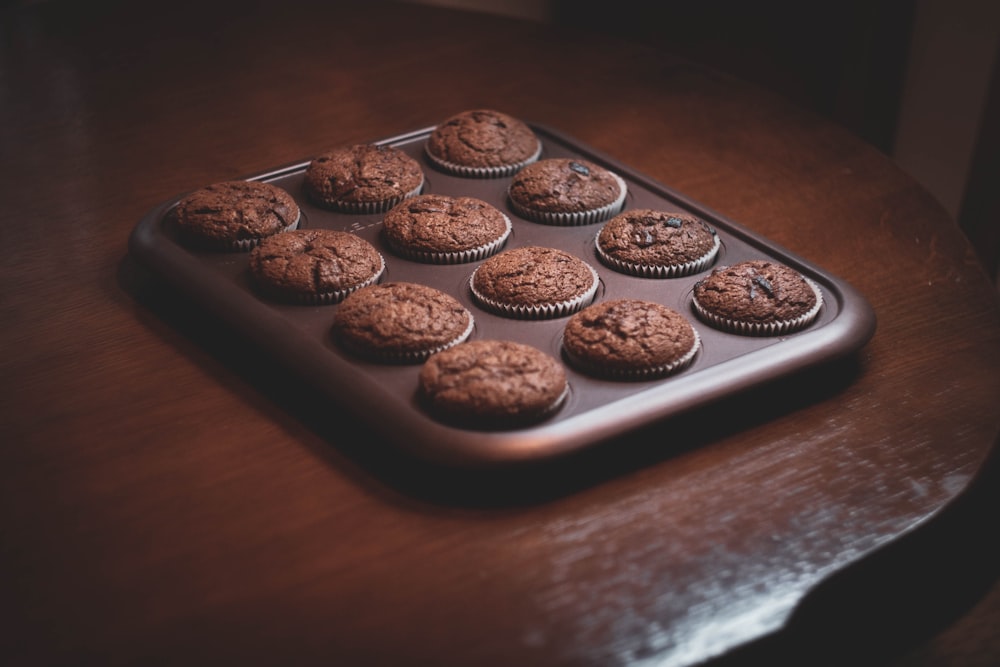 a chocolate muffin tray on a wooden table