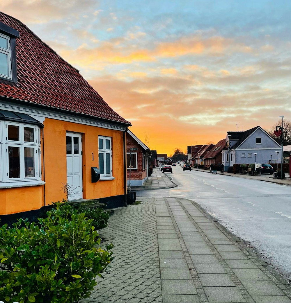 a street lined with houses with a sky in the background