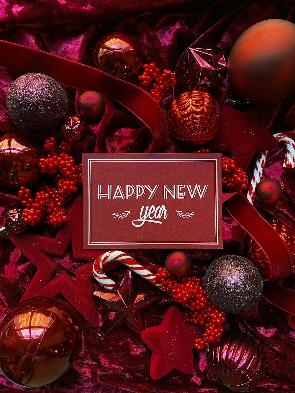 a happy new year card surrounded by christmas ornaments