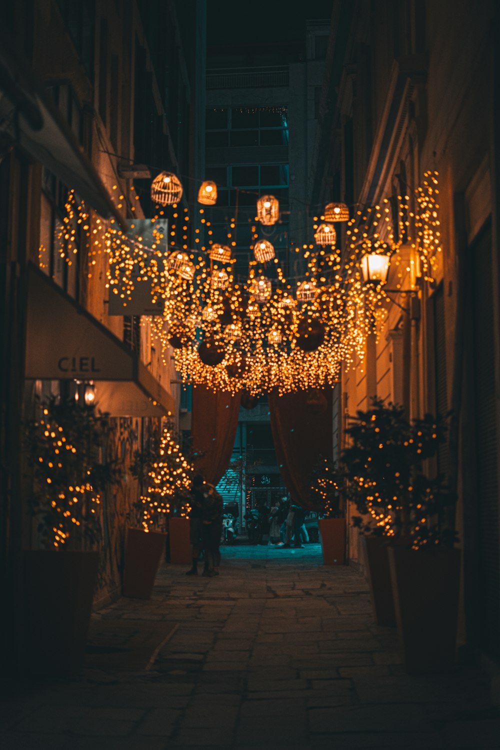 a street with a bunch of lights hanging from the side of it
