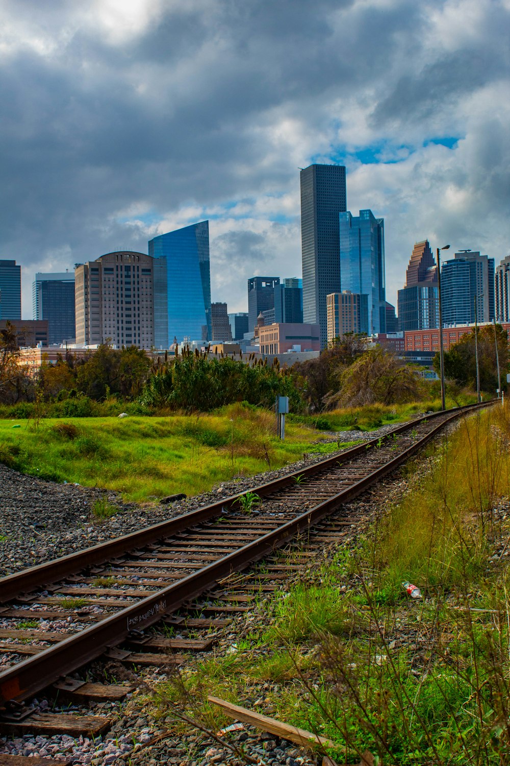 a train track with a city in the background