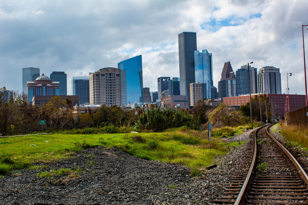 a train track with a city in the background