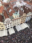 A panoramic view of a historic plaza surrounded by colonial architecture and lively market stalls.