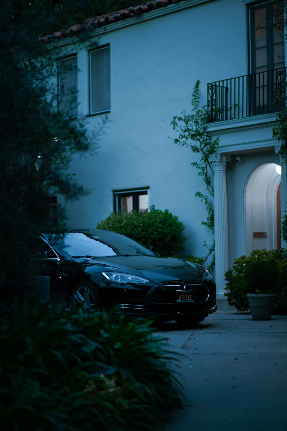 a car parked in front of a house at night