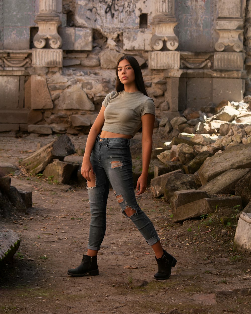 a woman standing in front of a stone building