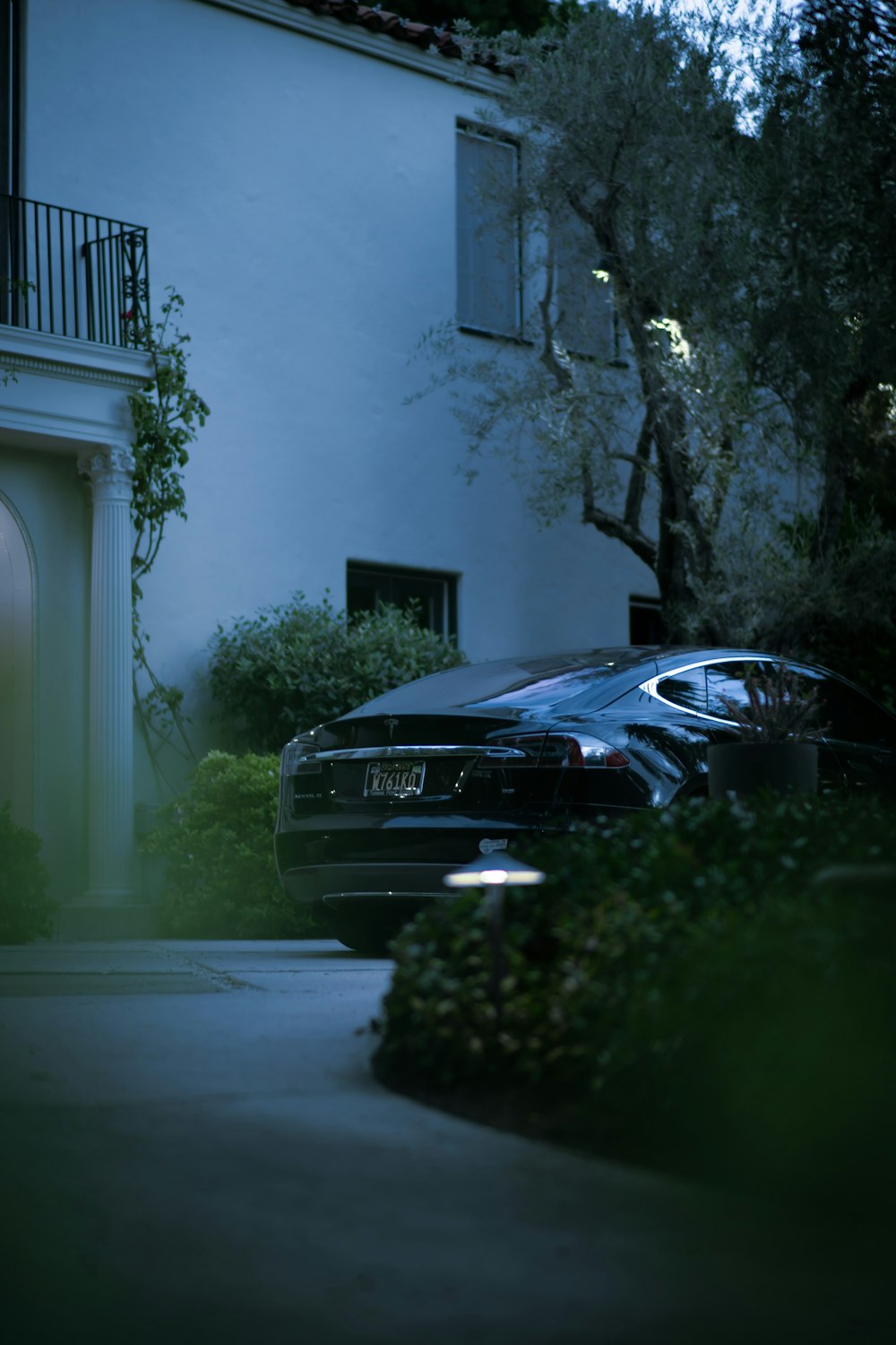 a car parked in front of a house at night