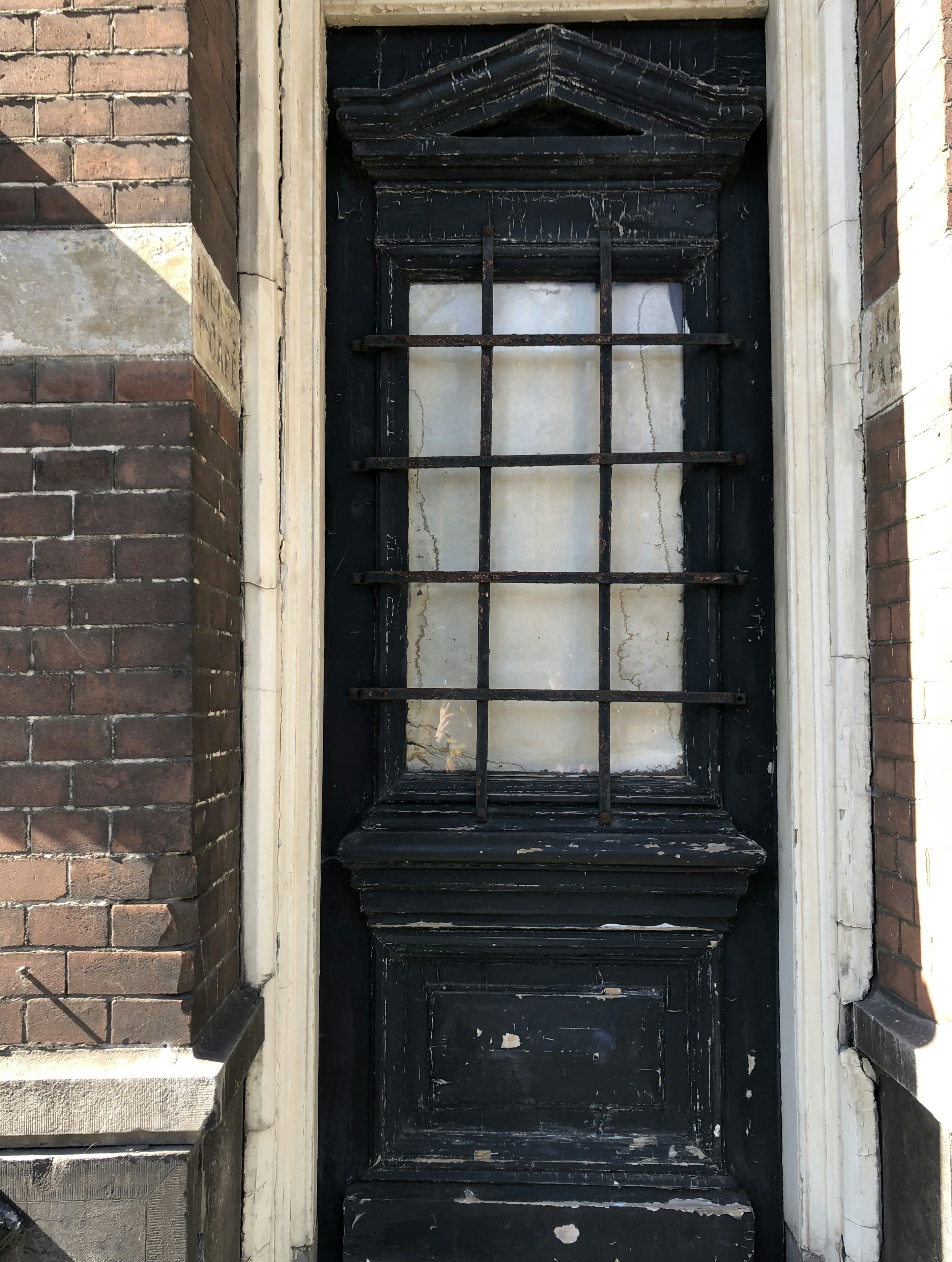 a black door with a window on the side of a building