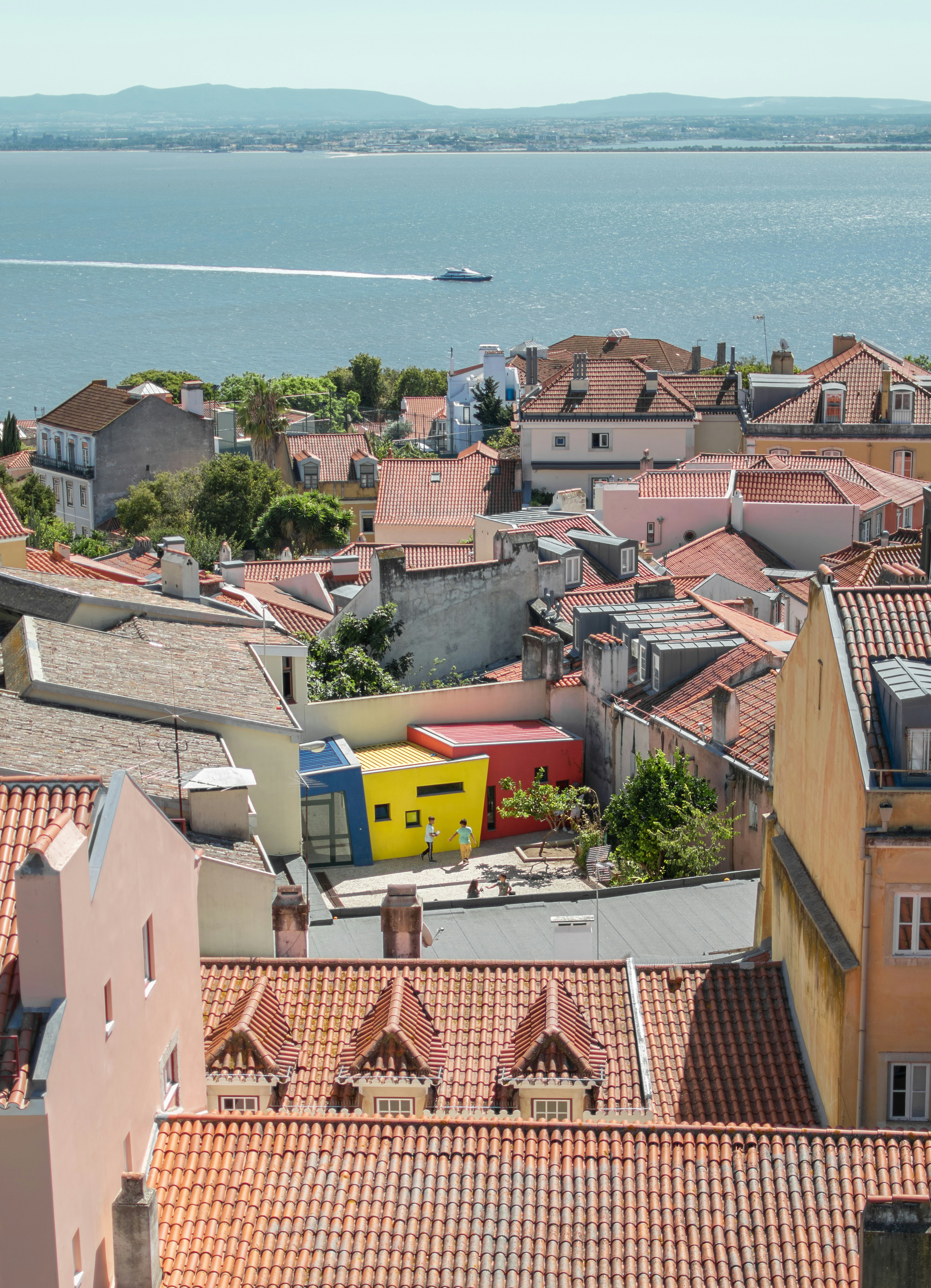 a view of a city with a body of water in the background