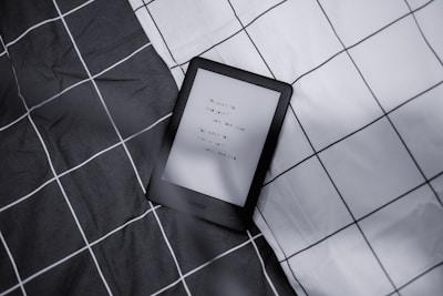 A sleek dark Kindle reader displaying the cover of the AI Author Accelerator ebook.