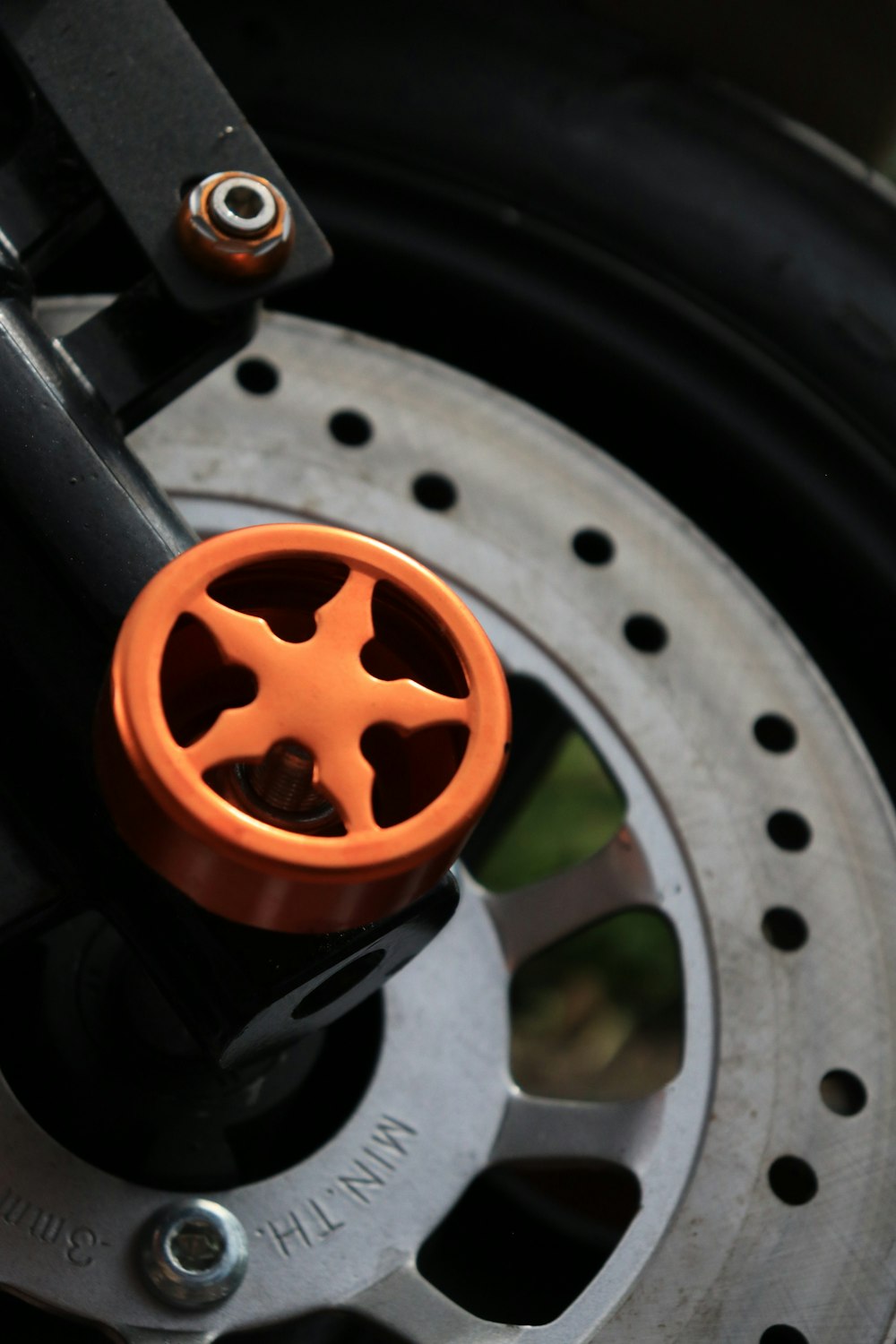 a close up of an orange wheel on a motorcycle