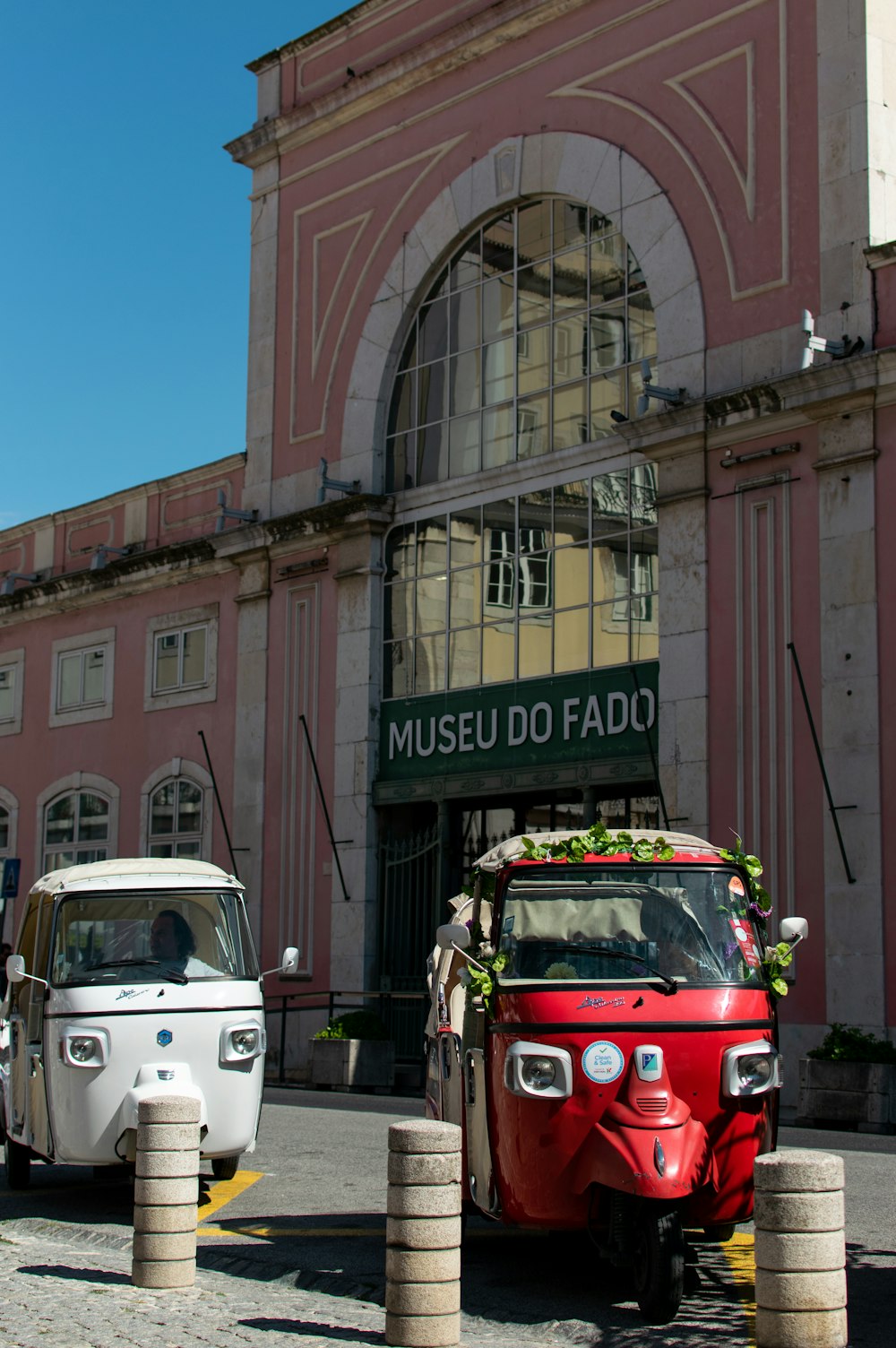 a red and white truck parked in front of a building