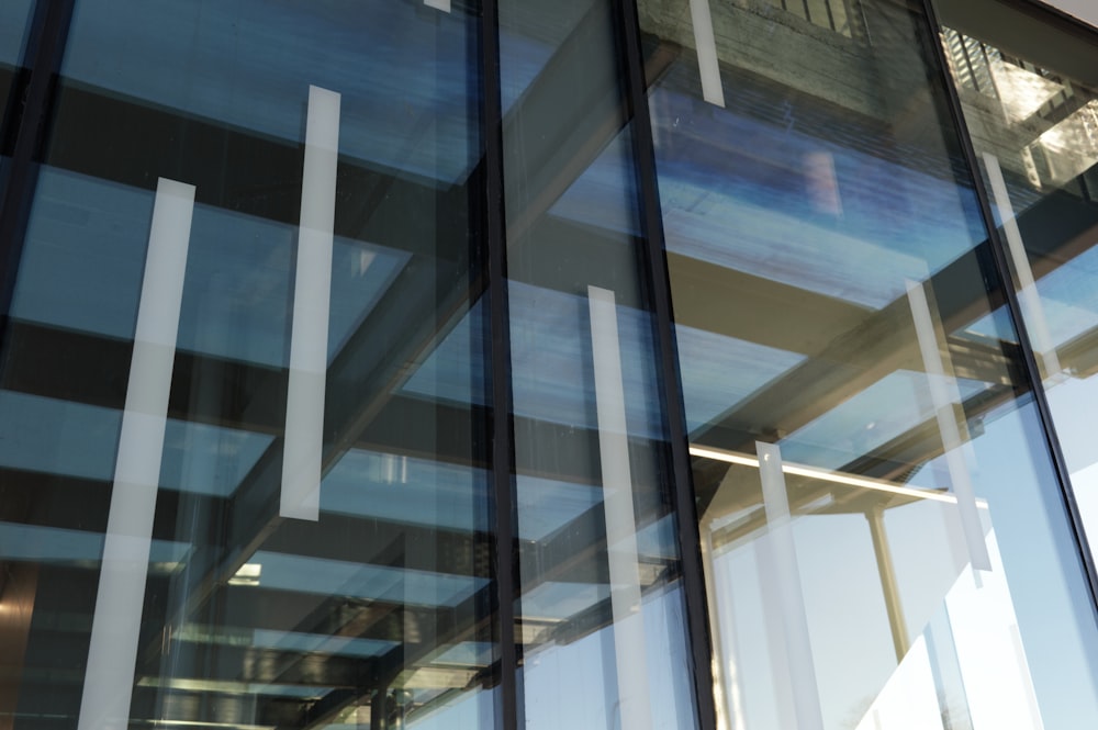 a close up of a glass wall with a building in the background