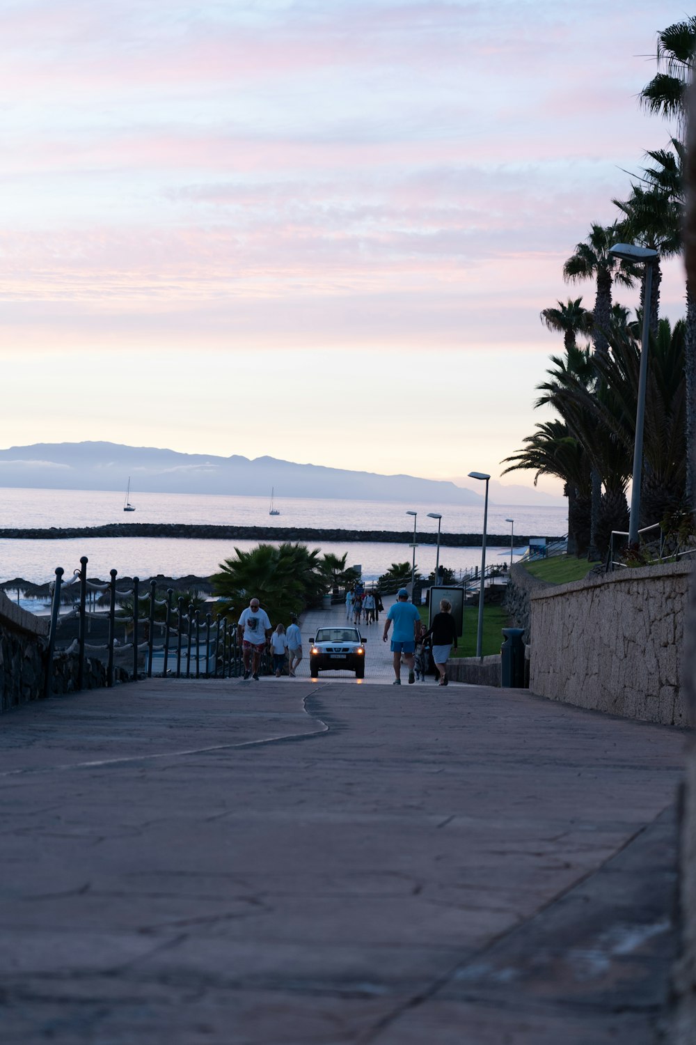 a couple of people that are walking down a sidewalk