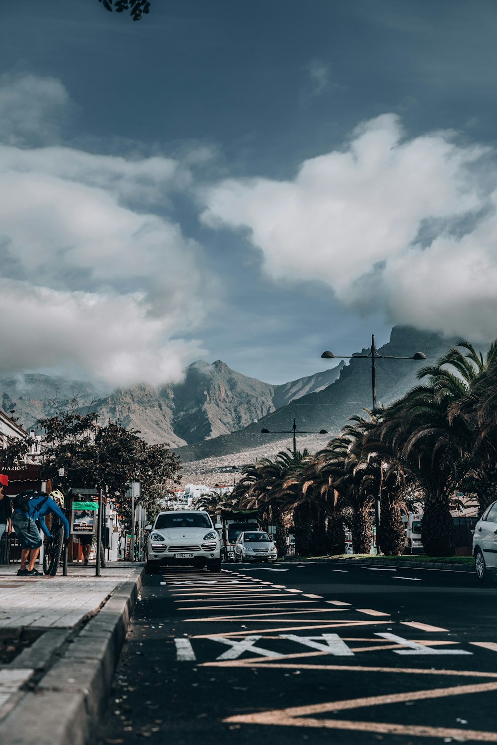 a street scene with cars parked on the side of the road