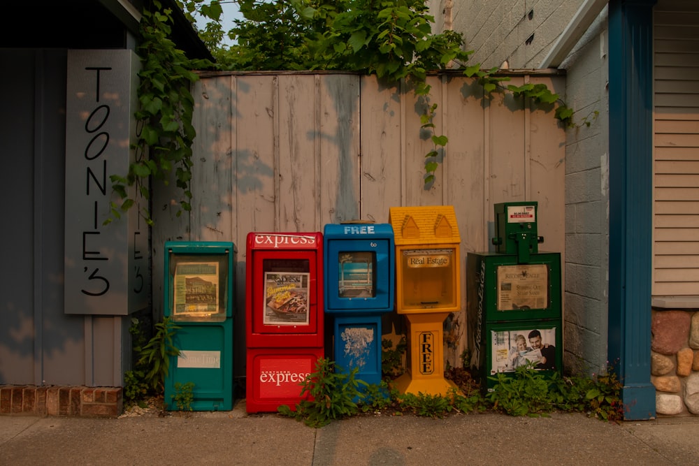 a row of vending machines sitting next to a building