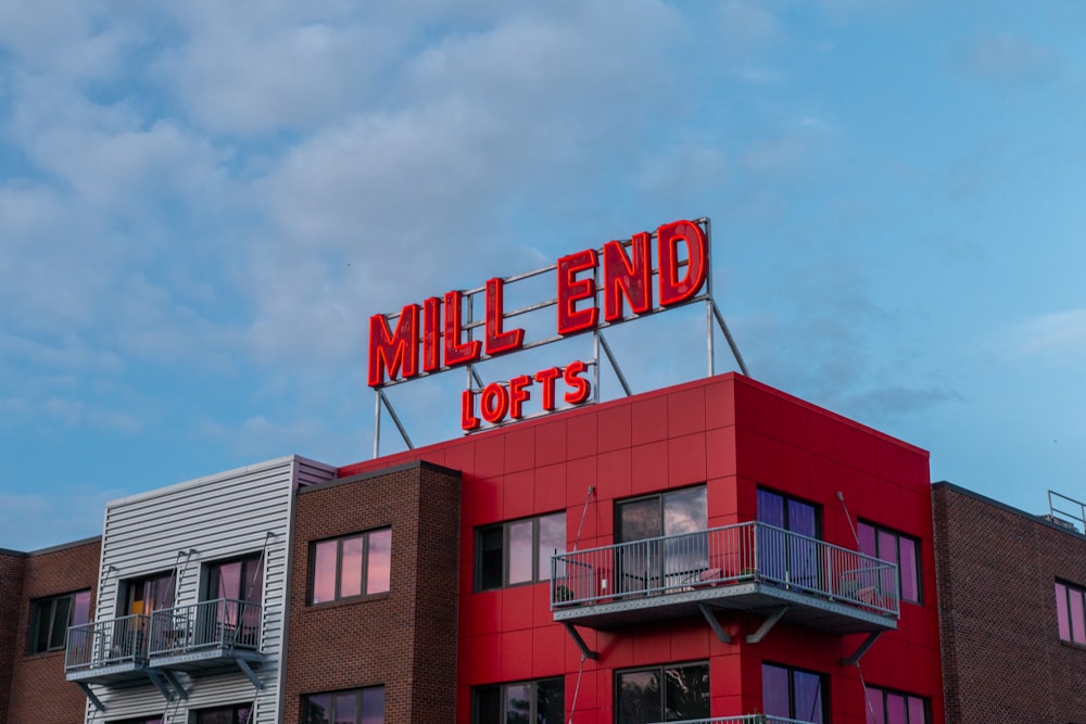 a red building with a sign that reads mill end lofts