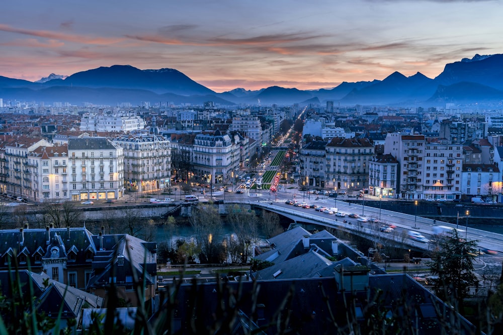 a view of a city with mountains in the background