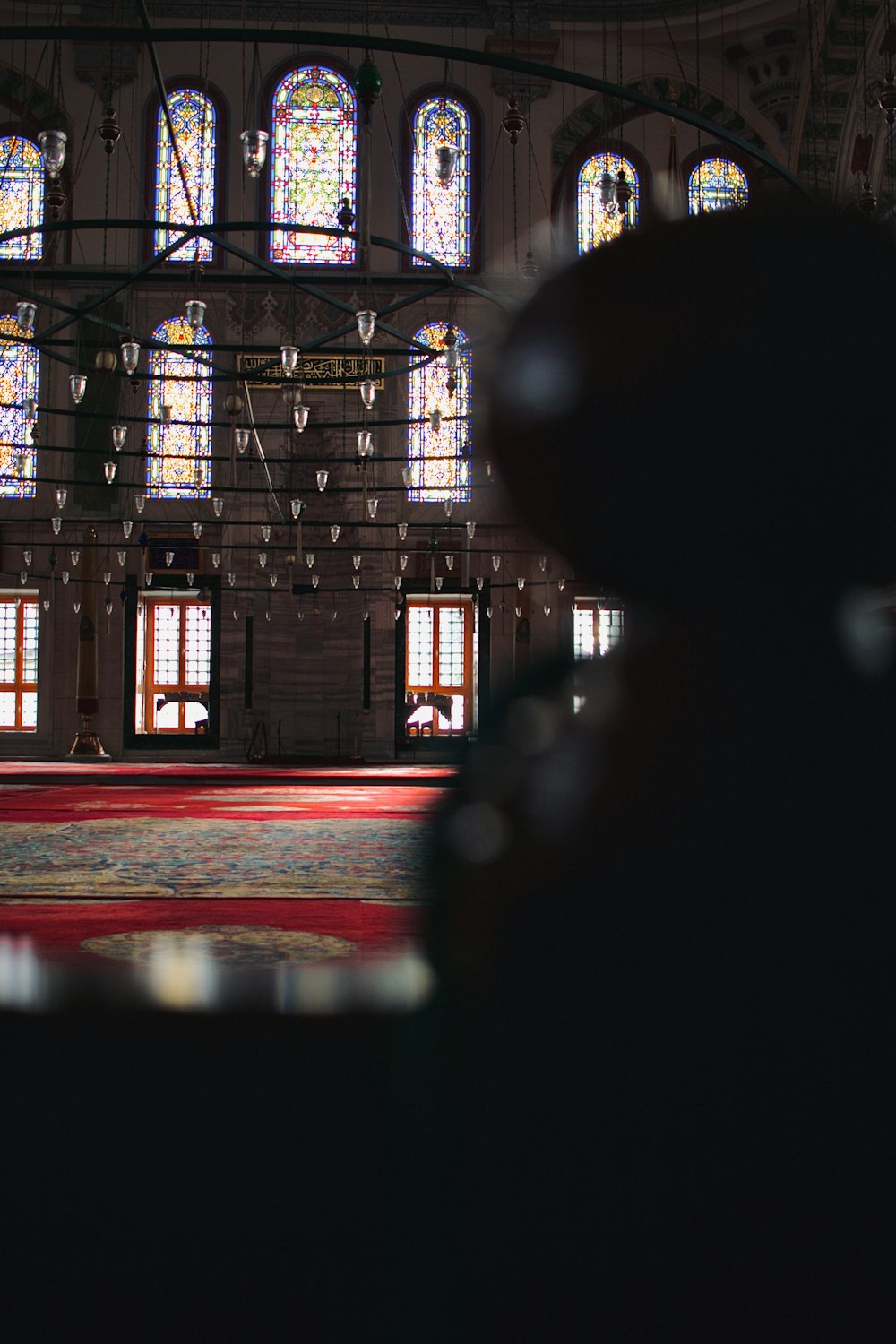 a view of the inside of a building with stained glass windows