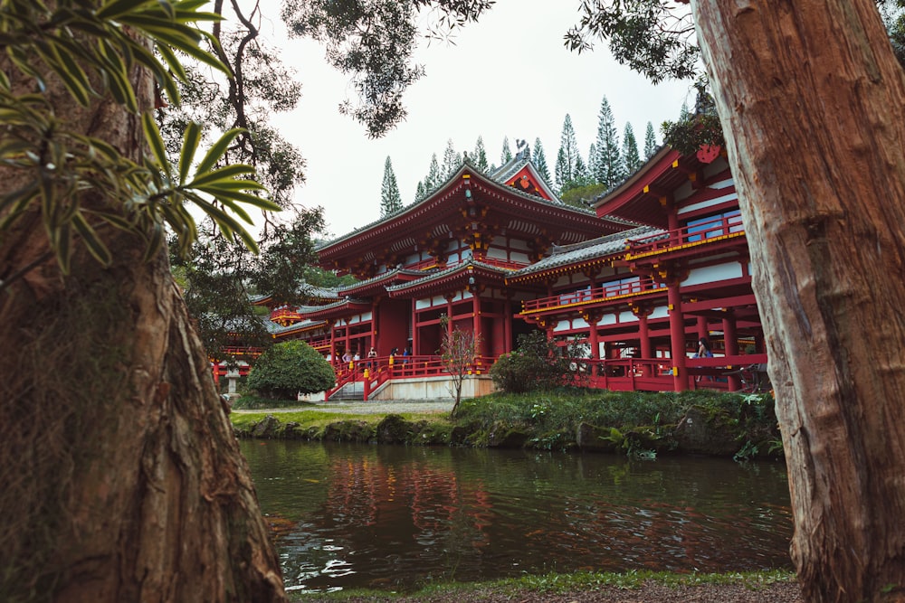 a red building sitting next to a body of water