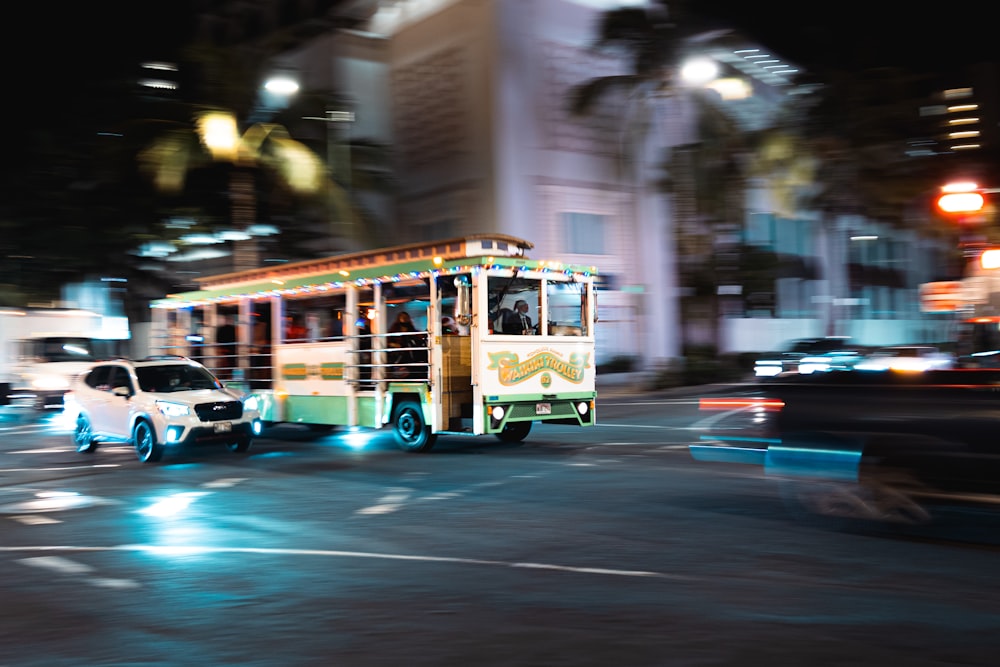 a bus driving down a city street at night