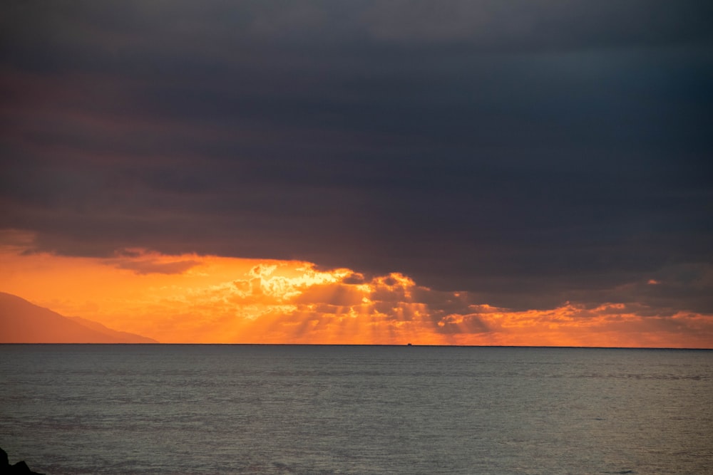 a large body of water under a cloudy sky