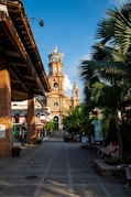 a large clock tower towering over a city street