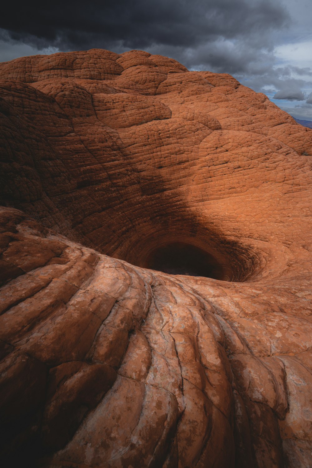 a rock formation with a hole in the middle of it