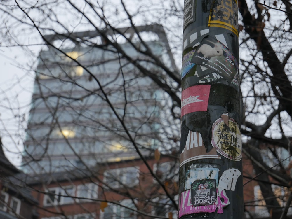 a pole with a bunch of stickers on it