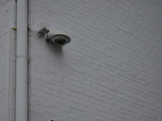 a security camera mounted to the side of a building