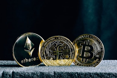 three bitcoins sitting on top of a table