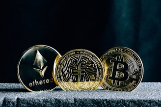 three bitcoins sitting on top of a table