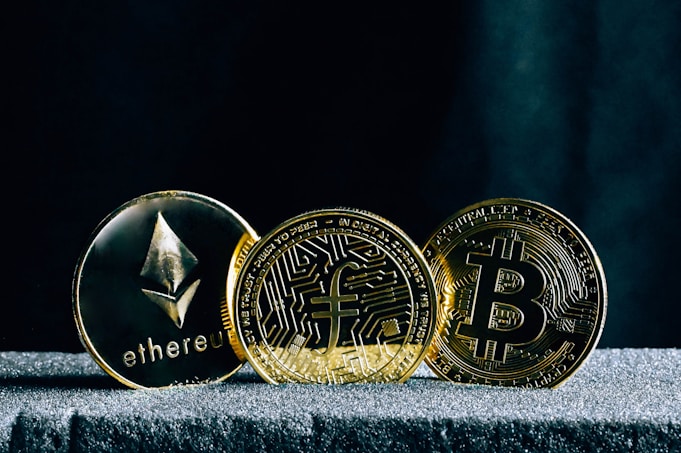 three bitcoins sitting on top of a table